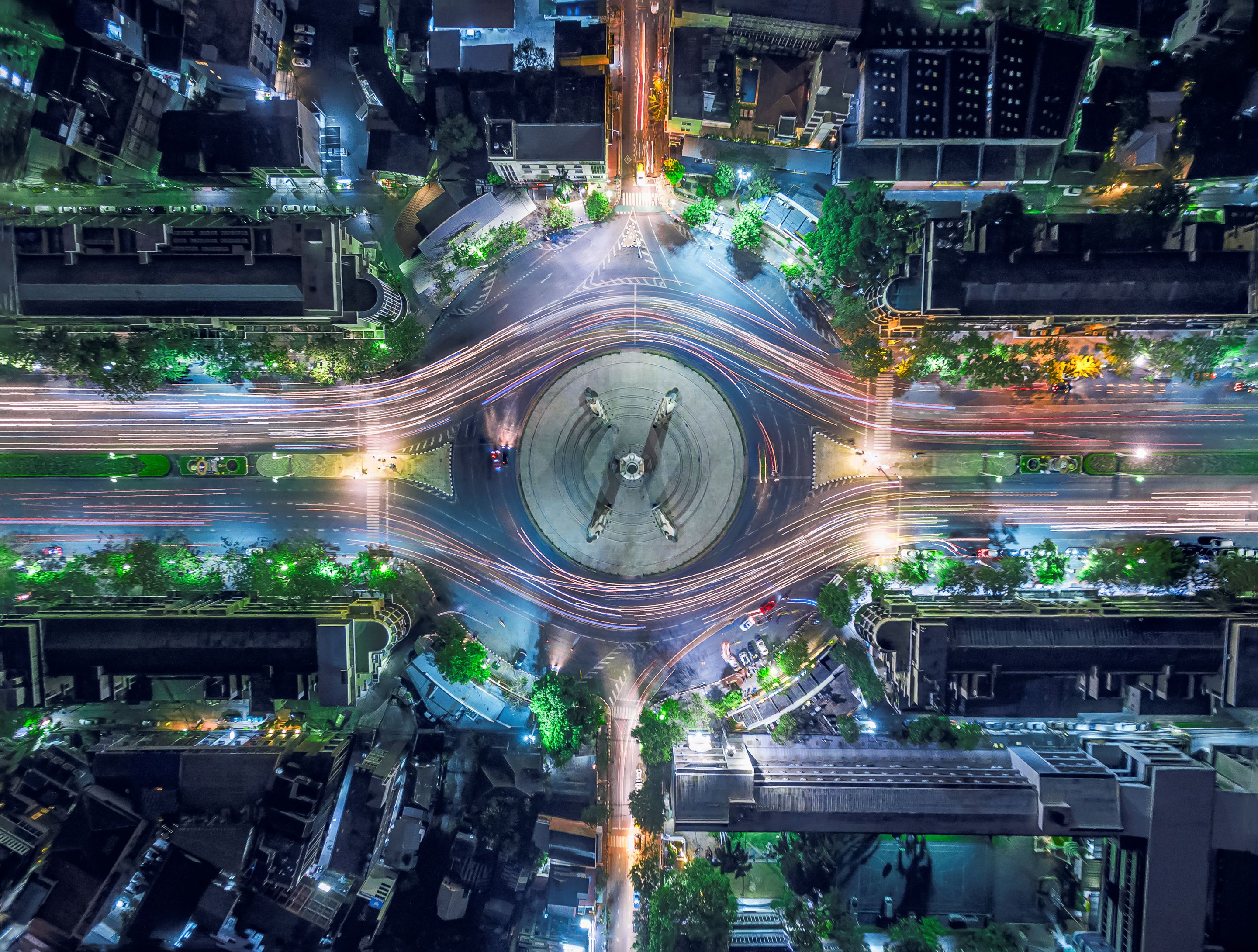Aerial view of city intersection with light trails